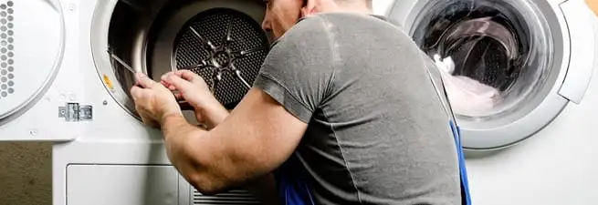 Dryer repair technician fixing a clothes dryer drum in Scottsdale, AZ