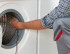Dryer repair technician diagnosing and servicing a clothes dryer in Scottsdale, AZ