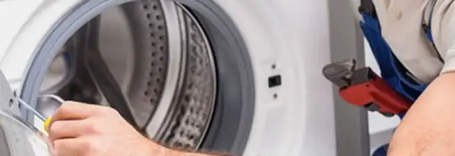 Appliance technician repairing a clothes dryer drum and internal parts in Scottsdale, AZ