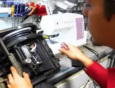 Vacuum repair technician servicing internal components on a workbench in Scottsdale, AZ