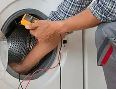 Washing machine repair technician testing a front-load washer with diagnostic tools in Scottsdale, AZ