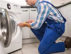 Washing machine repair technician servicing a front-load washer in Scottsdale, AZ